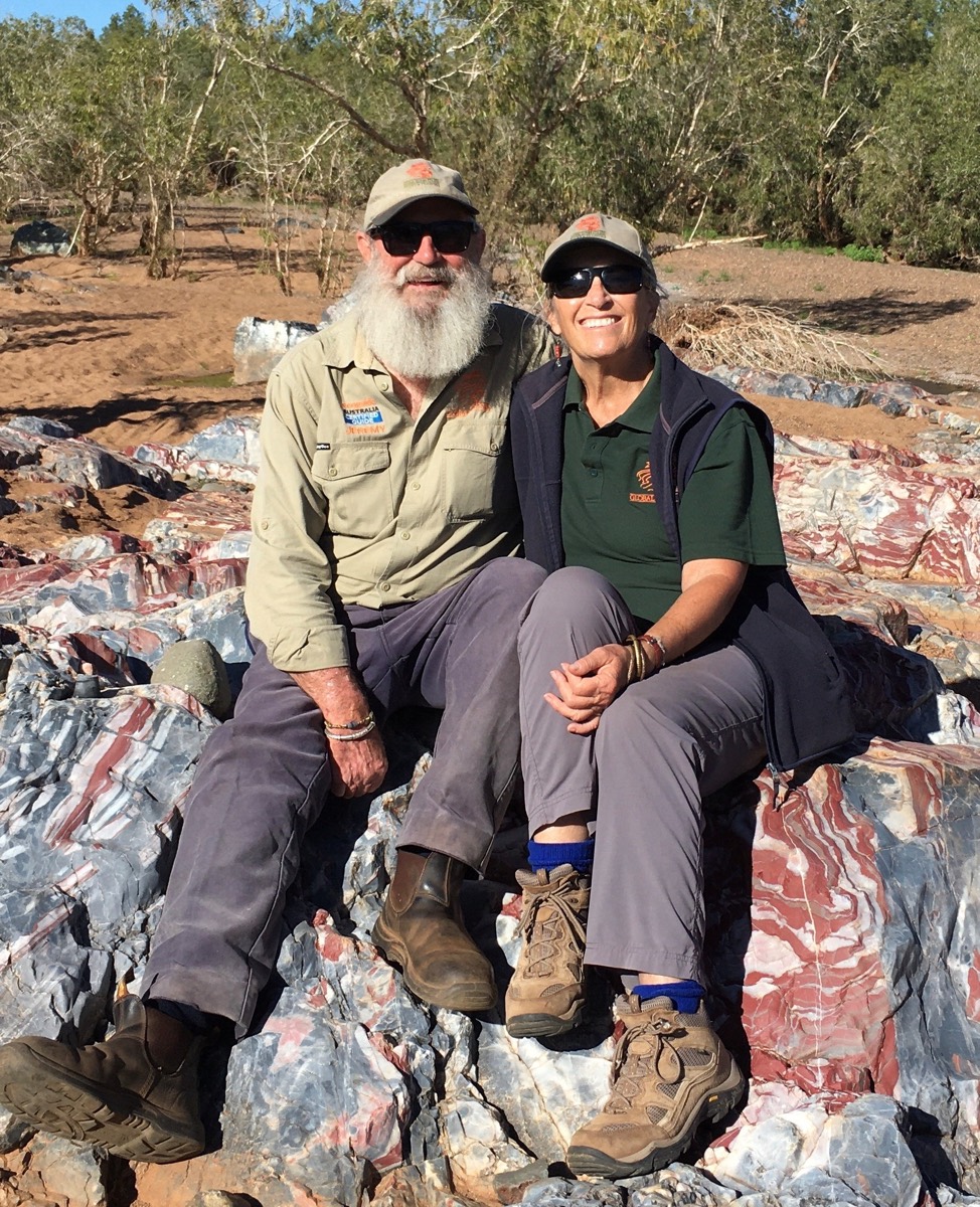 Jan and Jeremy sitting on striped jasper rocks at Marble Bar in the Pilbara, 2021